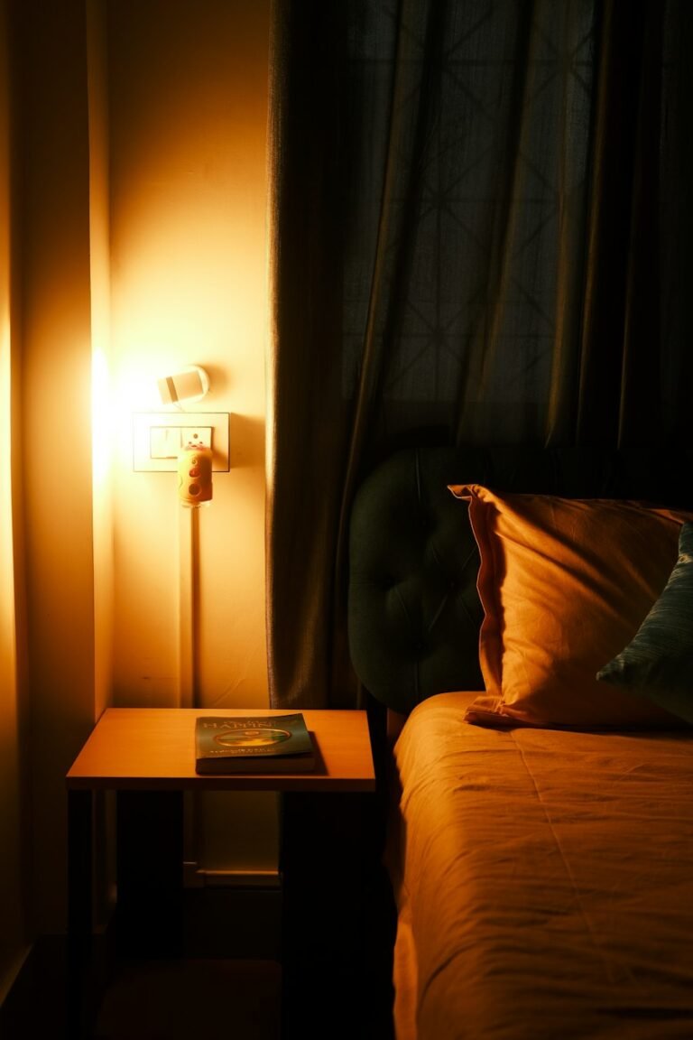 Bedroom corner lit by a warm wall lamp