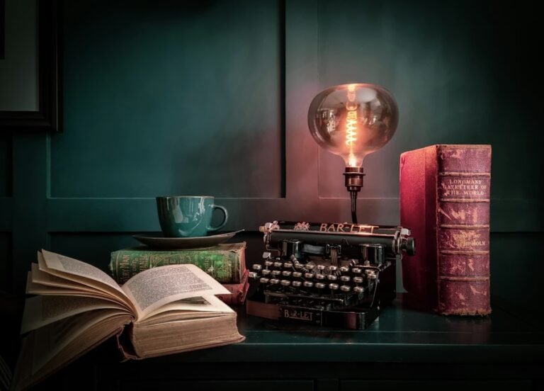 Vintage typewriter, lamp and open book on a desk